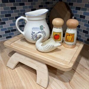 A George Oliver Bamboo Sofa Armrest Tray Table, which clips onto a couch arm